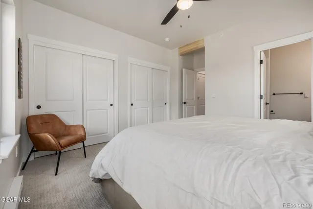 a bedroom with bed and chair