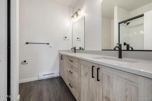 a bathroom with a double vanity sink and mirror