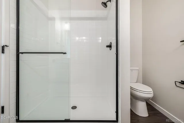 a bathroom with a toilet and a shower