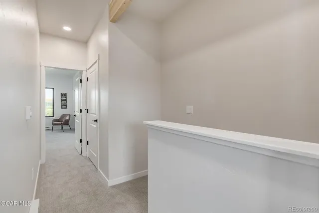 a view of a hallway with a room