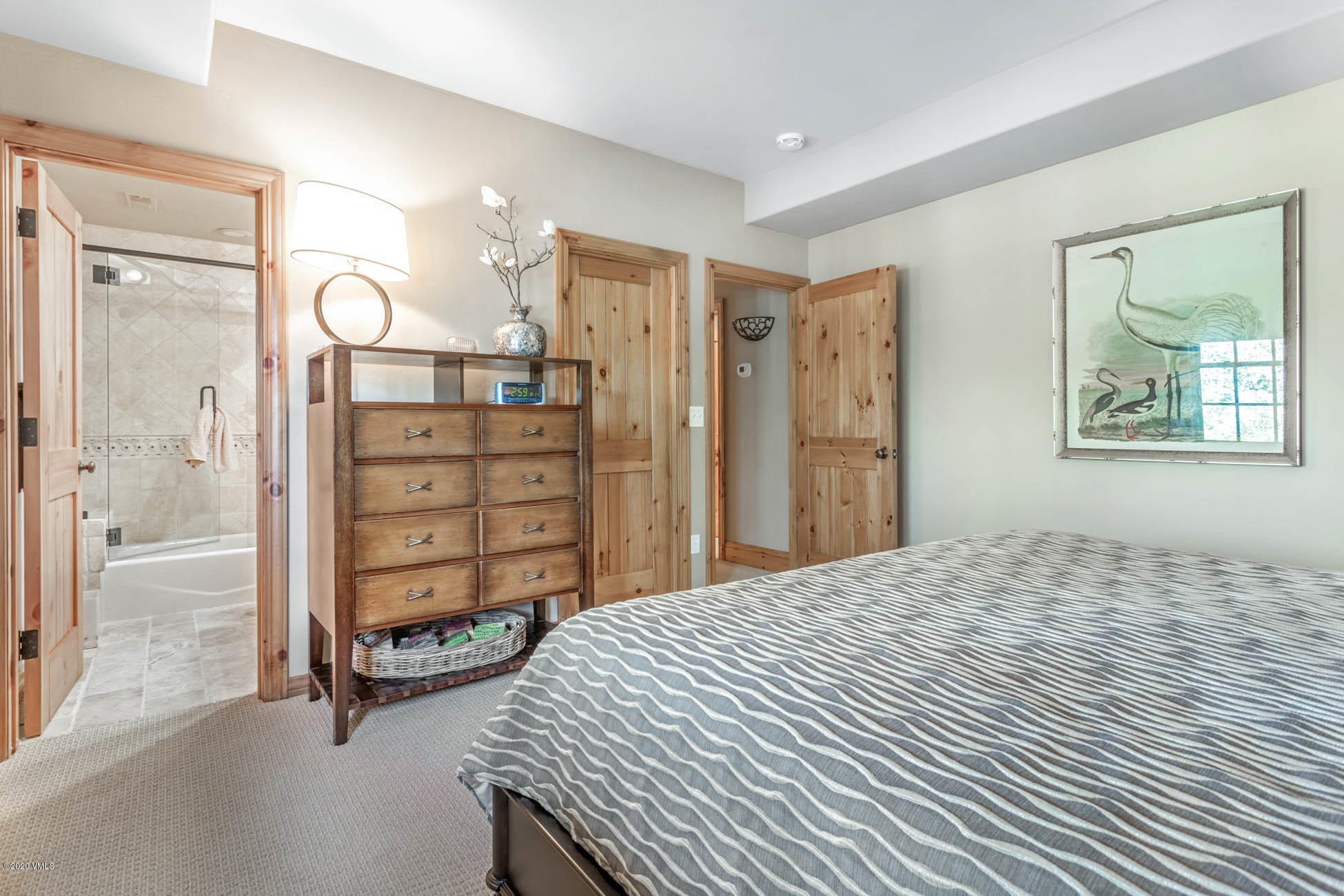 36 Fairway Lane Edwards, CO 81632 - Photo 25 of 37 a spacious bedroom with a bed and a cabinets