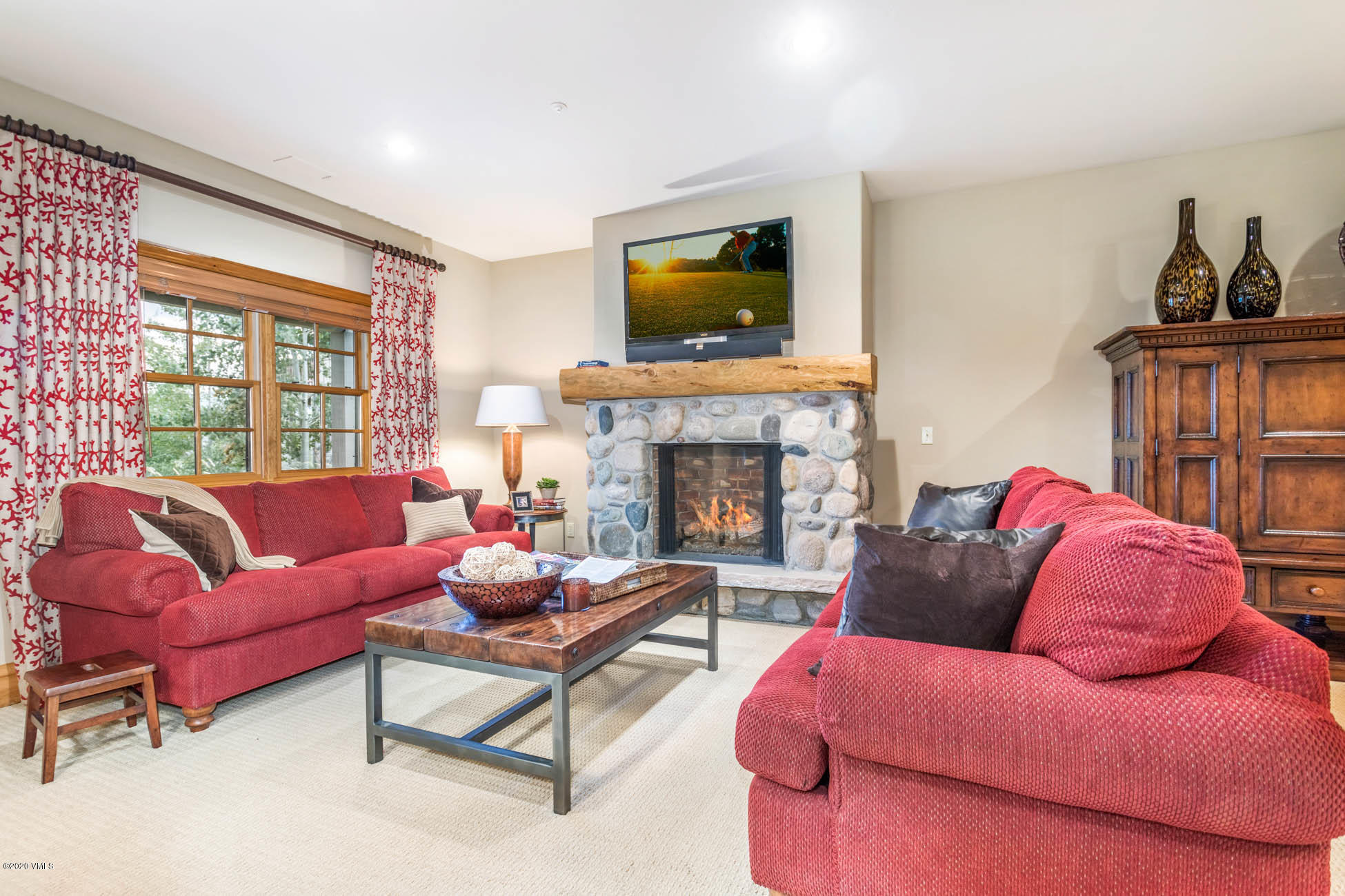 36 Fairway Lane Edwards, CO 81632 - Photo 31 of 37 a living room with furniture a flat screen tv and a fireplace