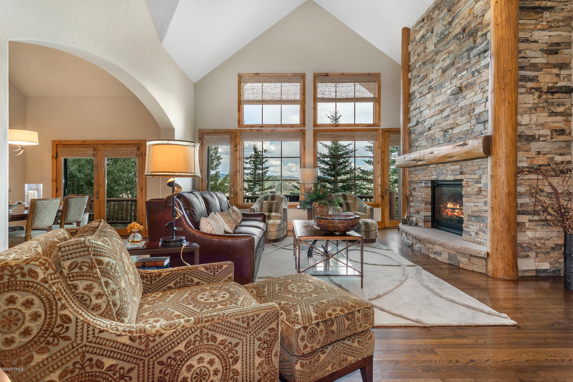 36 Fairway Lane Edwards, CO 81632 - Photo 4 of 37 a living room with furniture a fireplace and a floor to ceiling window