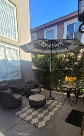 a backyard of a house with table and chairs