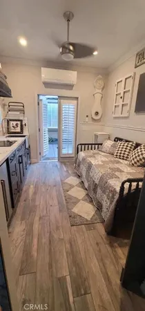 a view of a bedroom with furniture and window