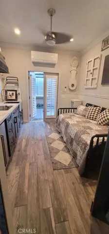 a view of a bedroom with furniture and window
