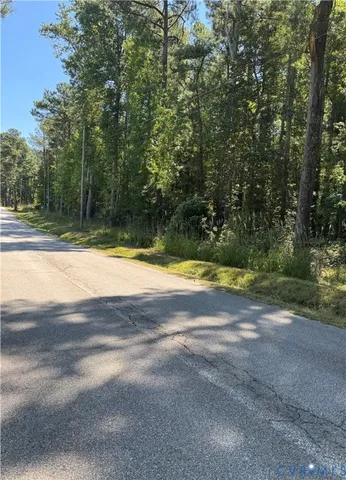 a view of swimming pool with large trees
