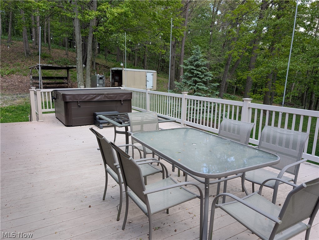 11154 Johnsford Road Southwest Beach City, OH 44608 - Photo 13 of 50 Spacious outdoor deck featuring light-toned composite decking, white railing, and a covered hot tub