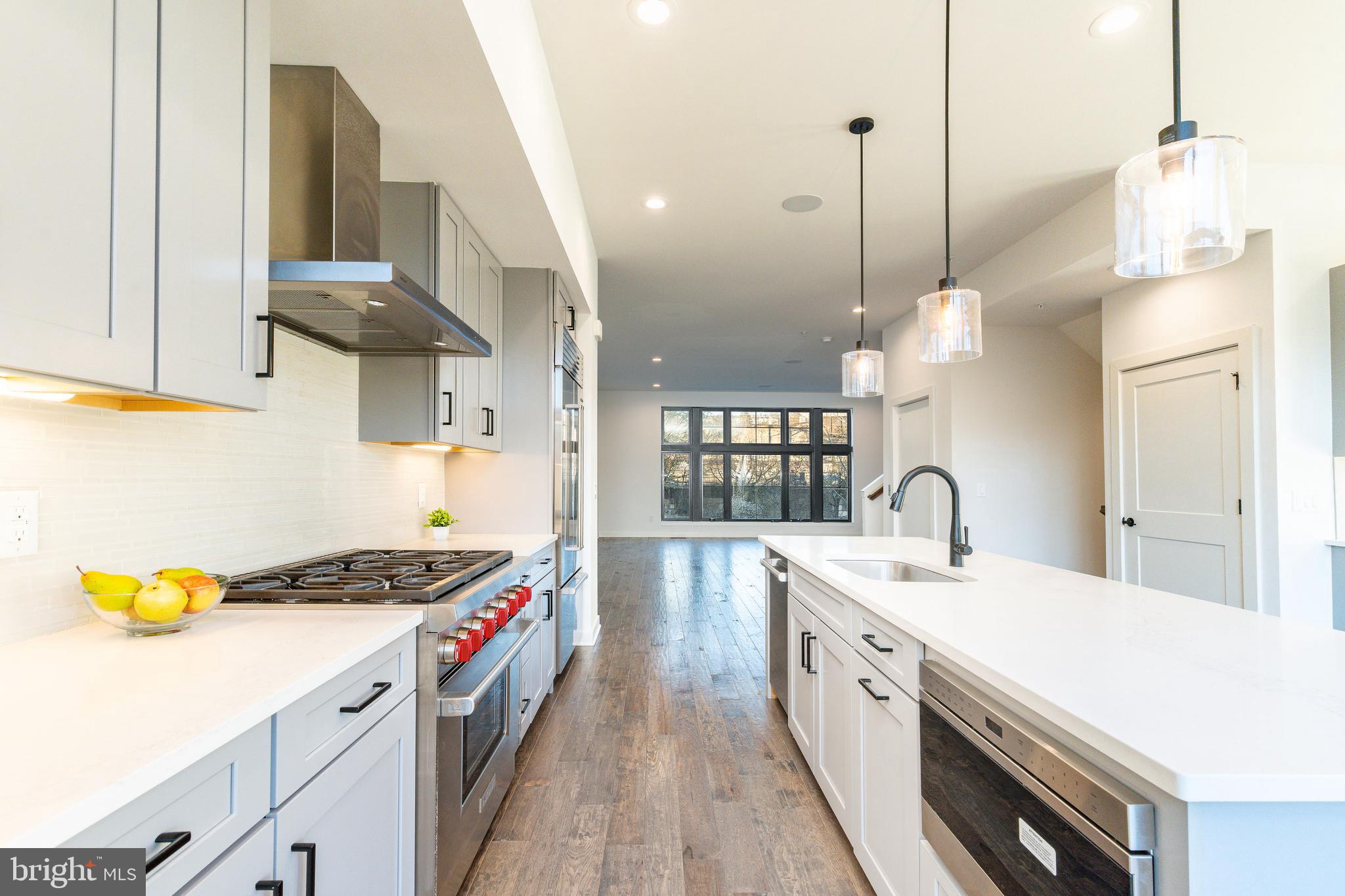 4523 Riverside Way Philadelphia, PA 19127 - Photo 14 of 50 a kitchen with a sink a stove and a wooden floor