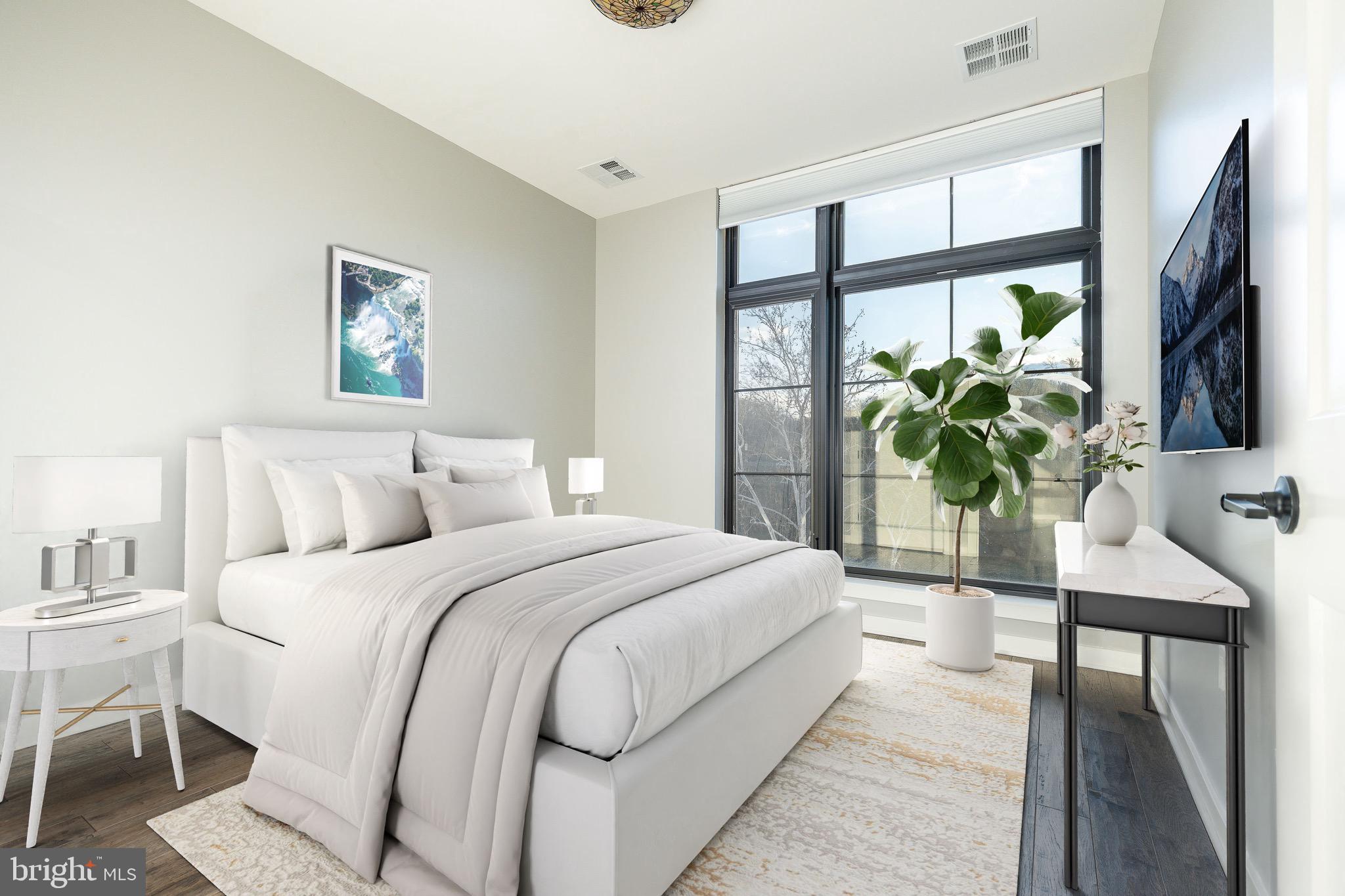 4523 Riverside Way Philadelphia, PA 19127 - Photo 22 of 50 a bedroom with a balcony a bed and a potted plant