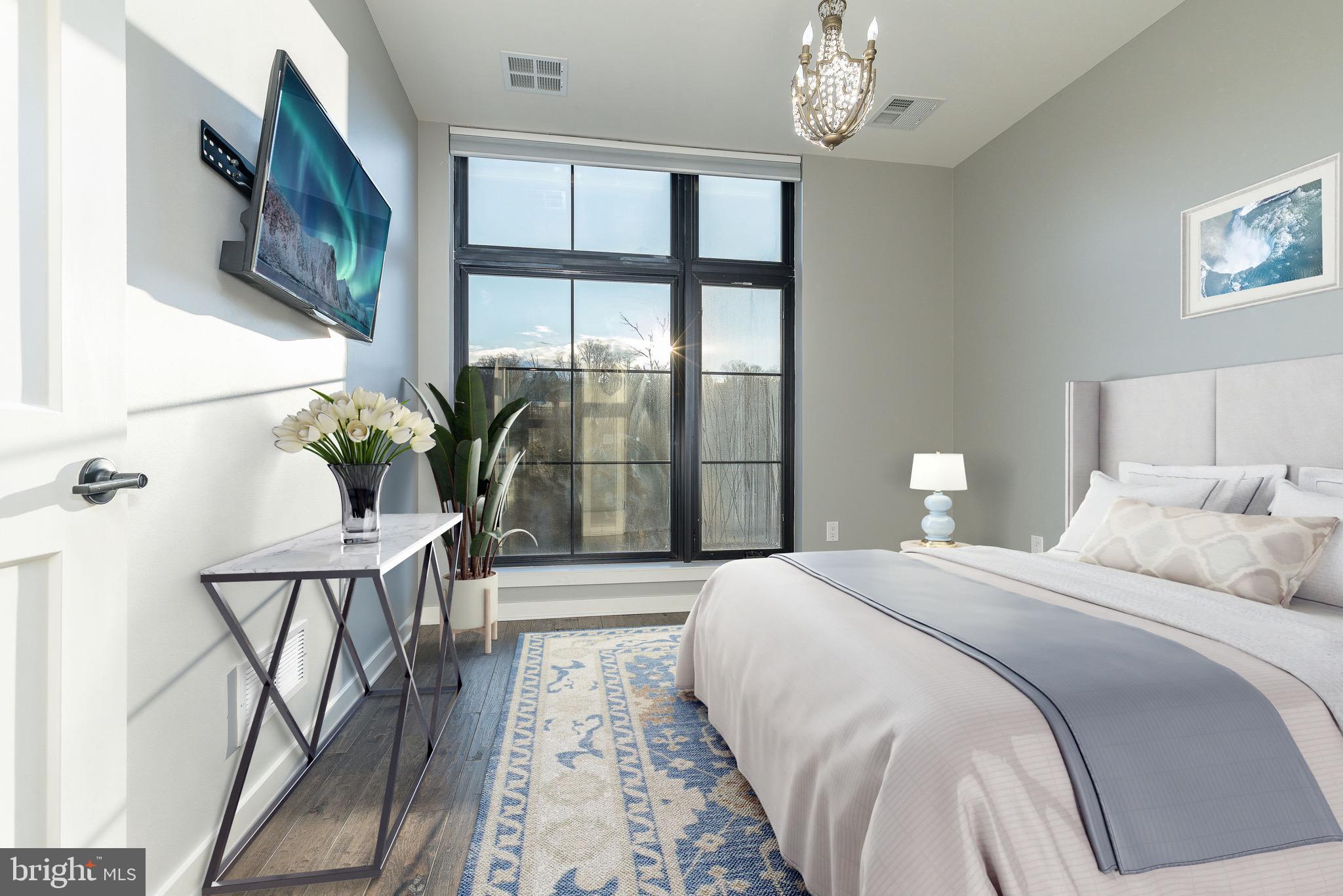 4523 Riverside Way Philadelphia, PA 19127 - Photo 24 of 50 a bedroom with a large bed and a chandelier