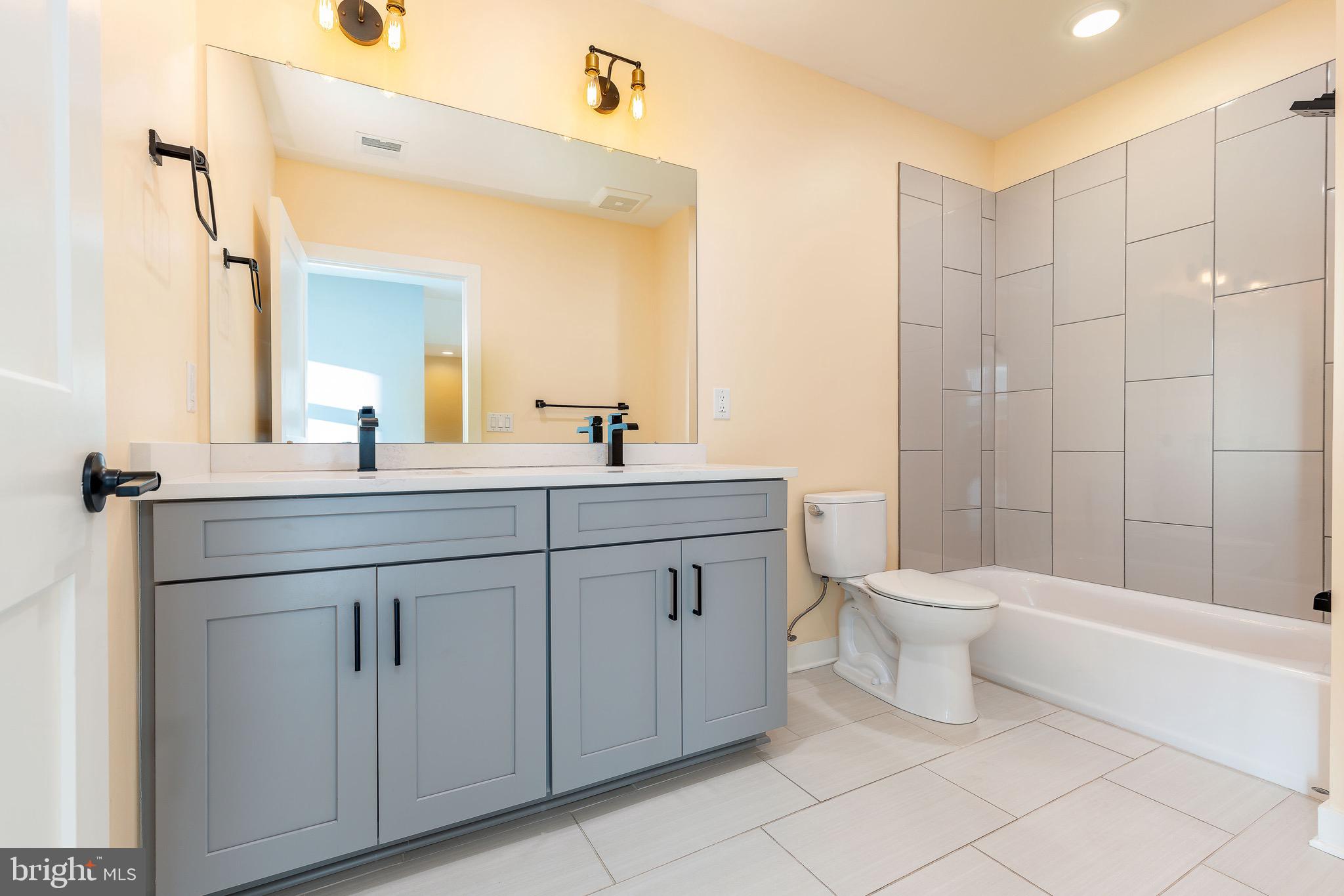 4523 Riverside Way Philadelphia, PA 19127 - Photo 25 of 50 a bathroom with a double vanity sink a toilet and a bathtub