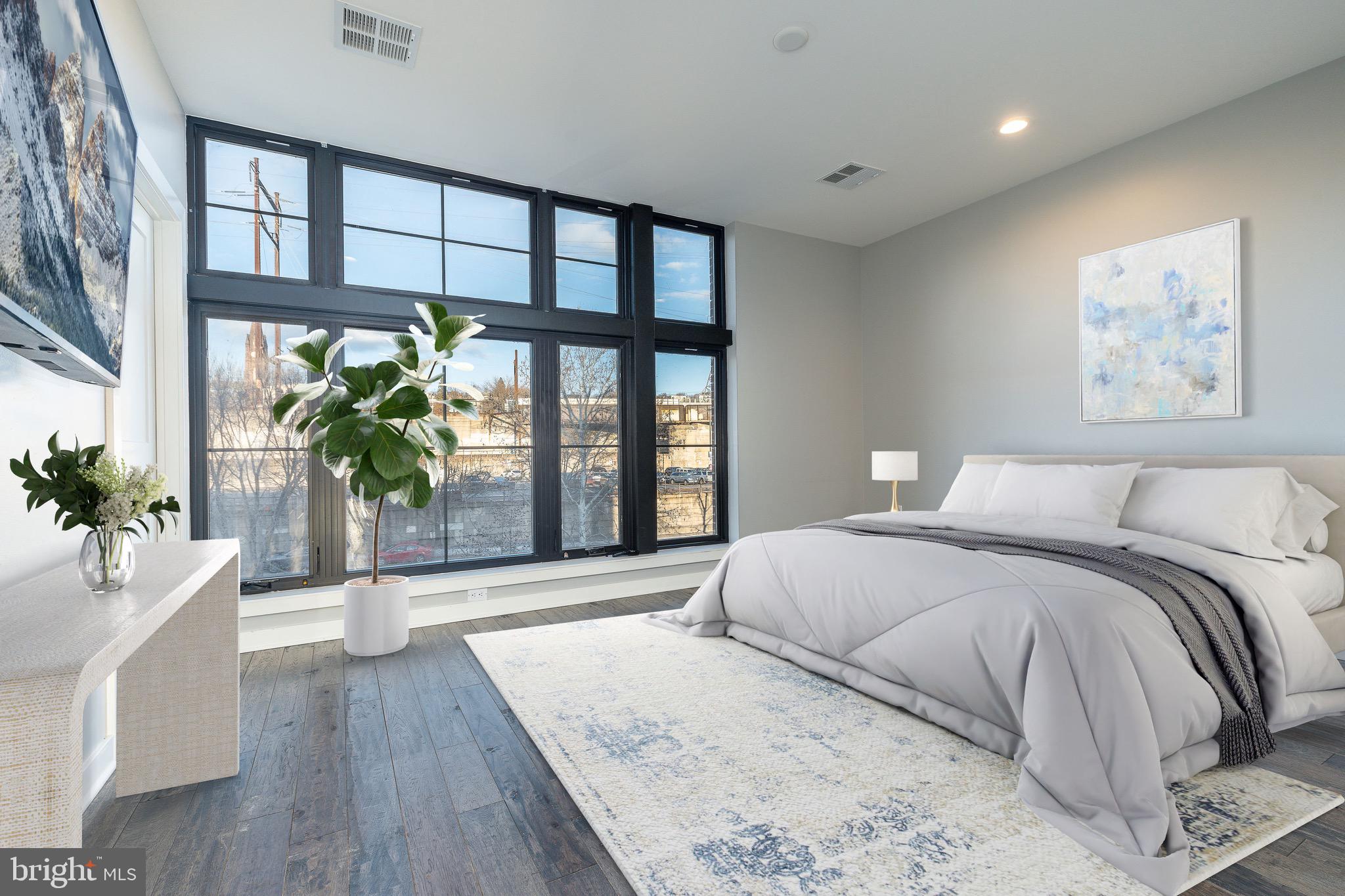 4523 Riverside Way Philadelphia, PA 19127 - Photo 26 of 50 a spacious bedroom with a large bed and a potted plant