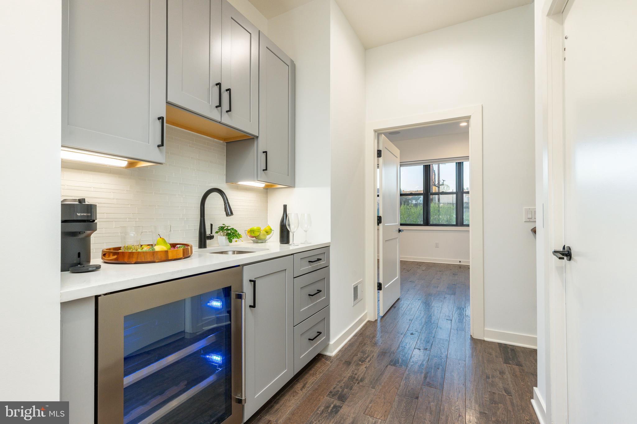 4523 Riverside Way Philadelphia, PA 19127 - Photo 41 of 50 a kitchen with stainless steel appliances a sink and wooden floor