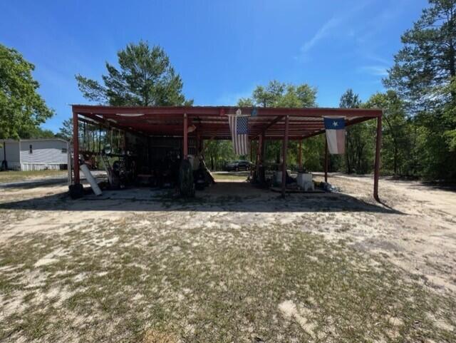 304 St James Road DeFuniak Springs, FL 32433 - Photo 18 of 37 a backyard of a house with barbeque oven table and chairs