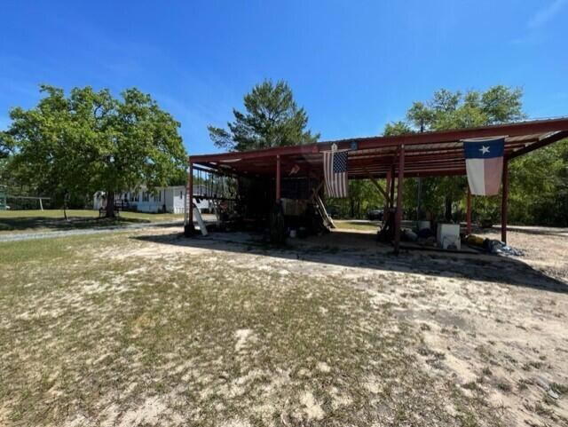 304 St James Road DeFuniak Springs, FL 32433 - Photo 19 of 37 a view of a house with backyard and sitting area