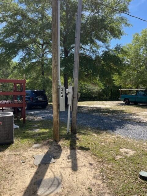 304 St James Road DeFuniak Springs, FL 32433 - Photo 24 of 37 a view of a patio with a table chairs and a fire pit