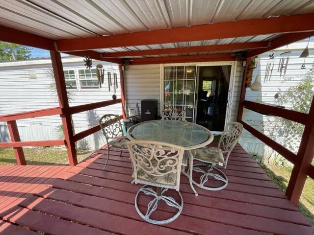 304 St James Road DeFuniak Springs, FL 32433 - Photo 30 of 37 a table and chairs in front of a house