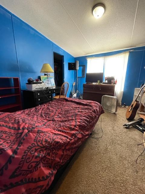 304 St James Road DeFuniak Springs, FL 32433 - Photo 36 of 37 a bedroom with a bed and a dresser with wooden floor