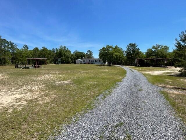 304 St James Road DeFuniak Springs, FL 32433 - Photo 7 of 37 a view of a field with trees in the background