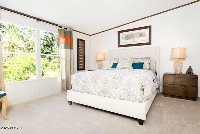 a spacious bedroom with a bed and a window