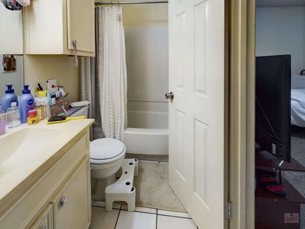 4111 Speedway, Unit 1 Austin, TX 78751 - Photo 8 of 14 a bathroom with a sink a toilet and shower