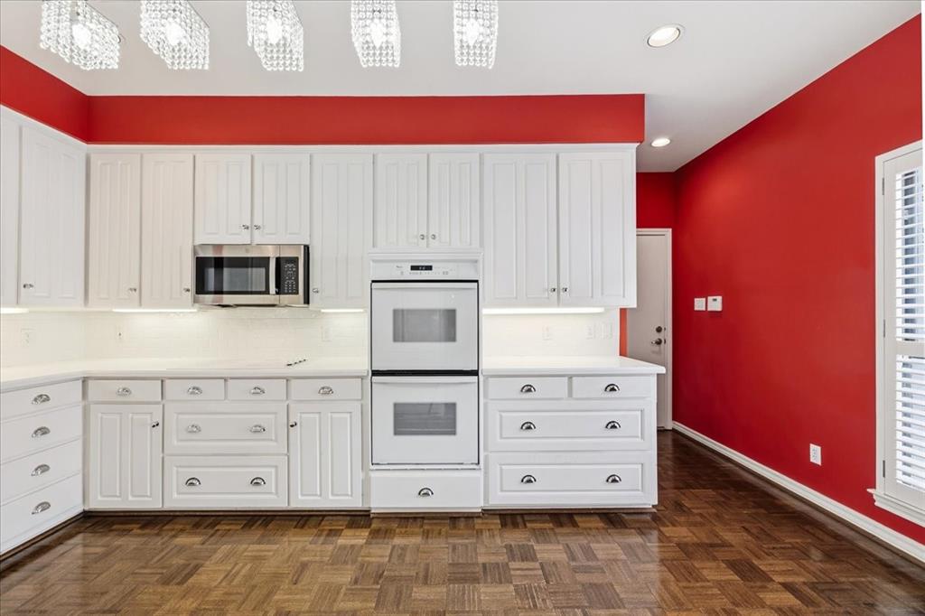 22 1 Main Place Benbrook, TX 76126 - Photo 20 of 40 a view of cabinets with stainless steel appliances granite countertop a stove a microwave and a refrigerator