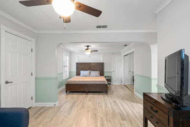 a bedroom with a bed and a chandelier