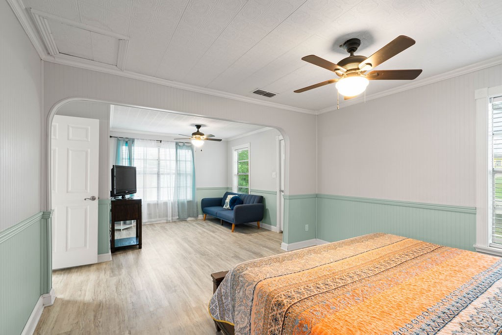 119 Century Drive Mathis, TX 78368 - Photo 14 of 38 a bedroom with a bed and a chandelier