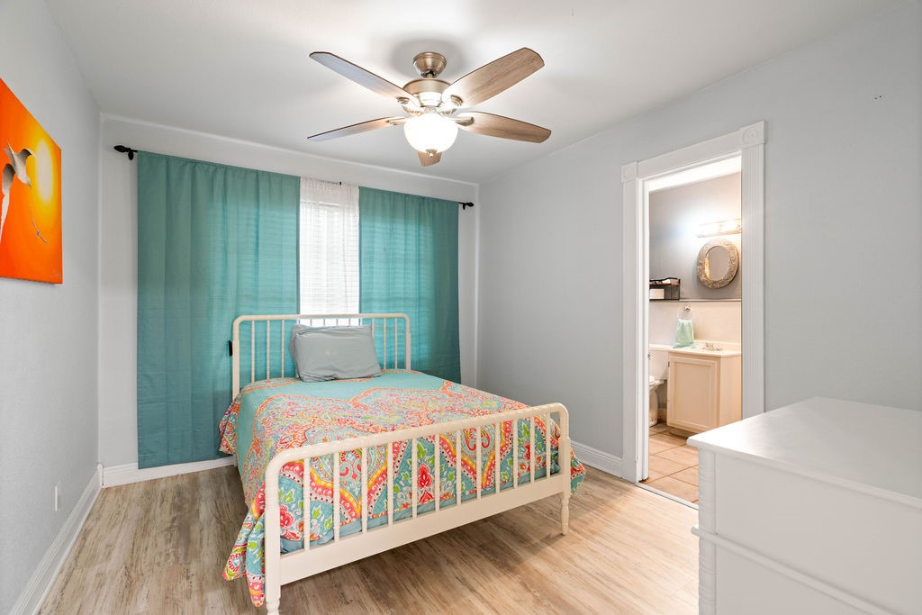 119 Century Drive Mathis, TX 78368 - Photo 16 of 38 a bedroom with a bed and a chandelier