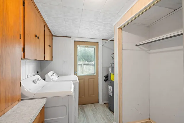 a view of a backyard with table and chairs and a large tree