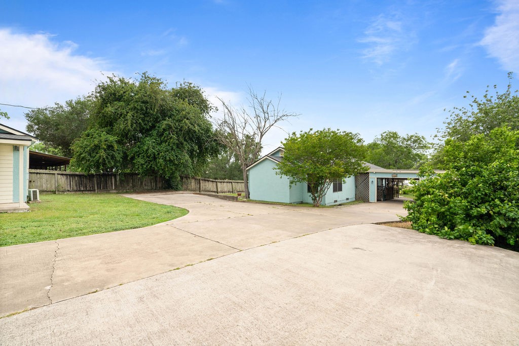 119 Century Drive Mathis, TX 78368 - Photo 2 of 38 a front view of a house with a yard and garage