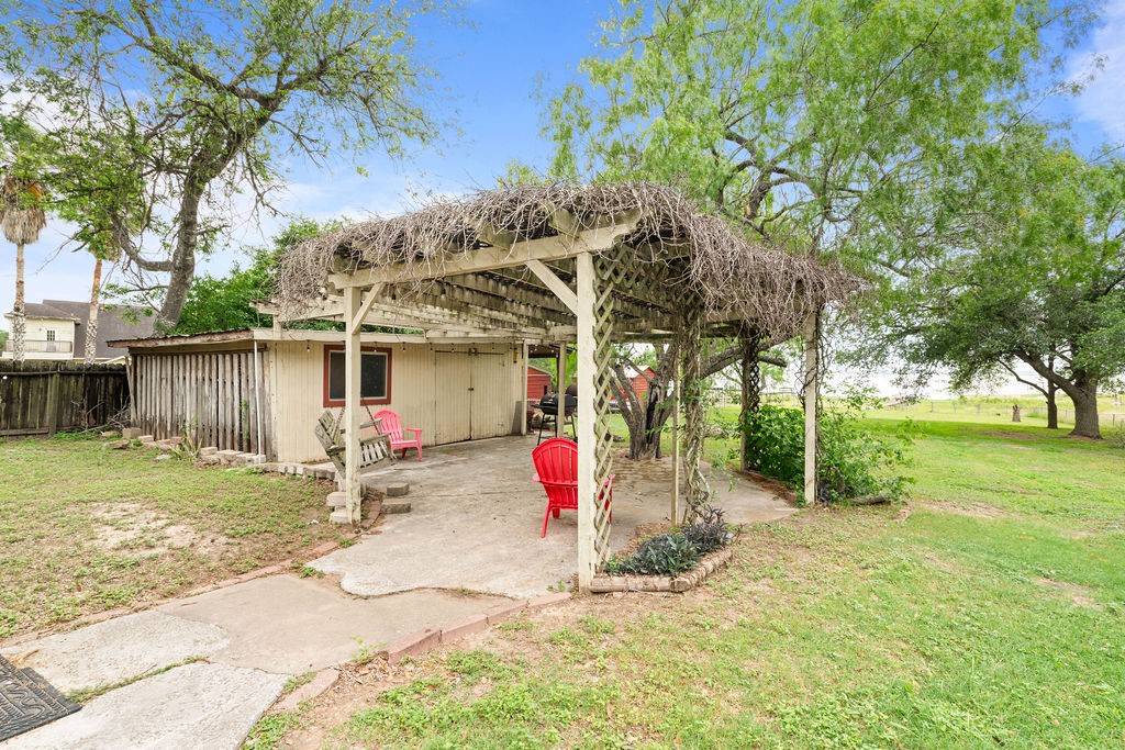 119 Century Drive Mathis, TX 78368 - Photo 21 of 38 a view of a backyard with table and chairs and a large tree