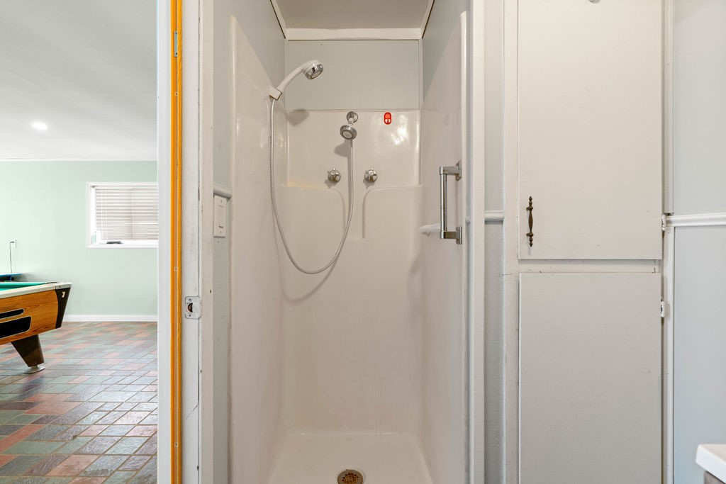 119 Century Drive Mathis, TX 78368 - Photo 26 of 38 a bathroom with a glass shower door