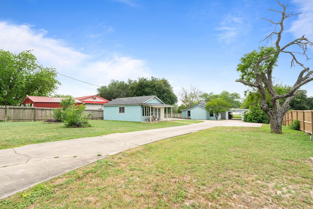 119 Century Drive Mathis, TX 78368 - Photo 4 of 38 a front view of a house with a yard and trees