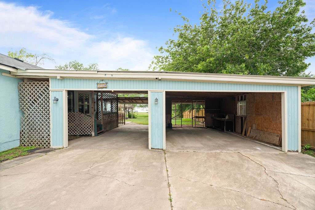 119 Century Drive Mathis, TX 78368 - Photo 5 of 38 a view of a house with parking space and a garage