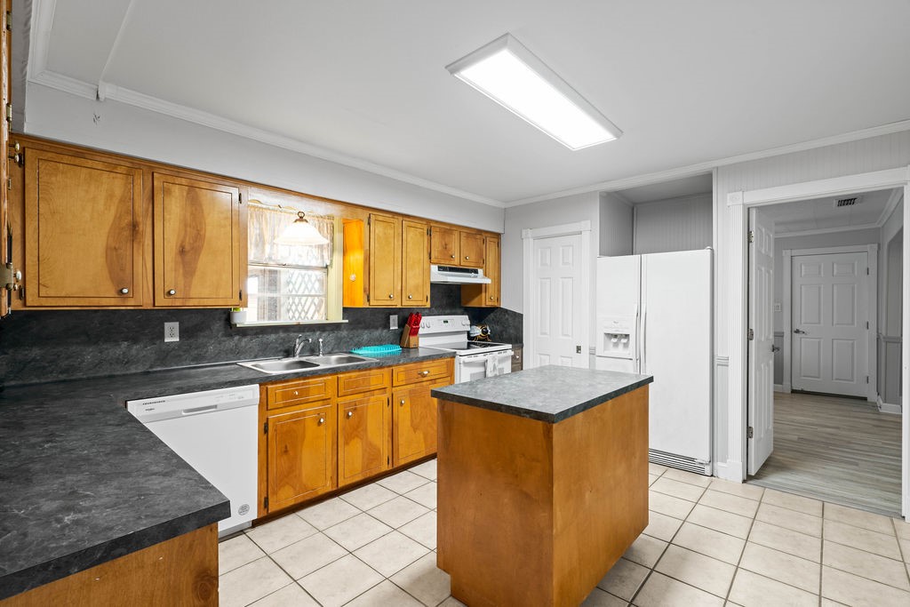 119 Century Drive Mathis, TX 78368 - Photo 9 of 38 a kitchen with stainless steel appliances granite countertop a sink a stove and a refrigerator