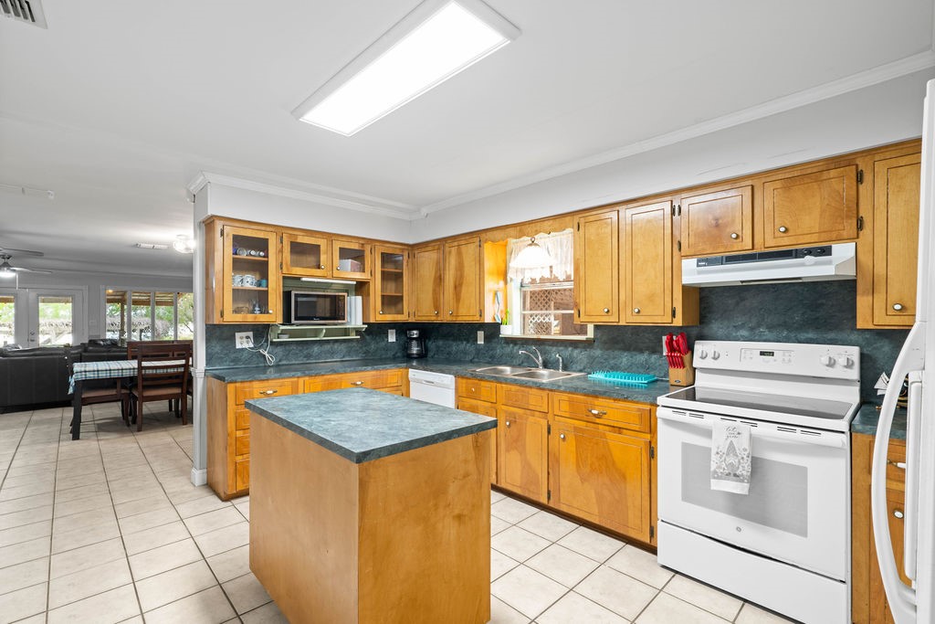119 Century Drive Mathis, TX 78368 - Photo 10 of 38 a kitchen that has a lot of cabinets in it and wooden floors