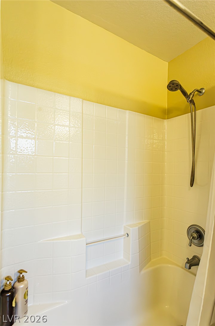 75 Tall Ruff Drive Las Vegas, NV 89148 - Photo 30 of 64 Crisp tiled walls and classic plumbing fixtures define this functional tub and shower combination.