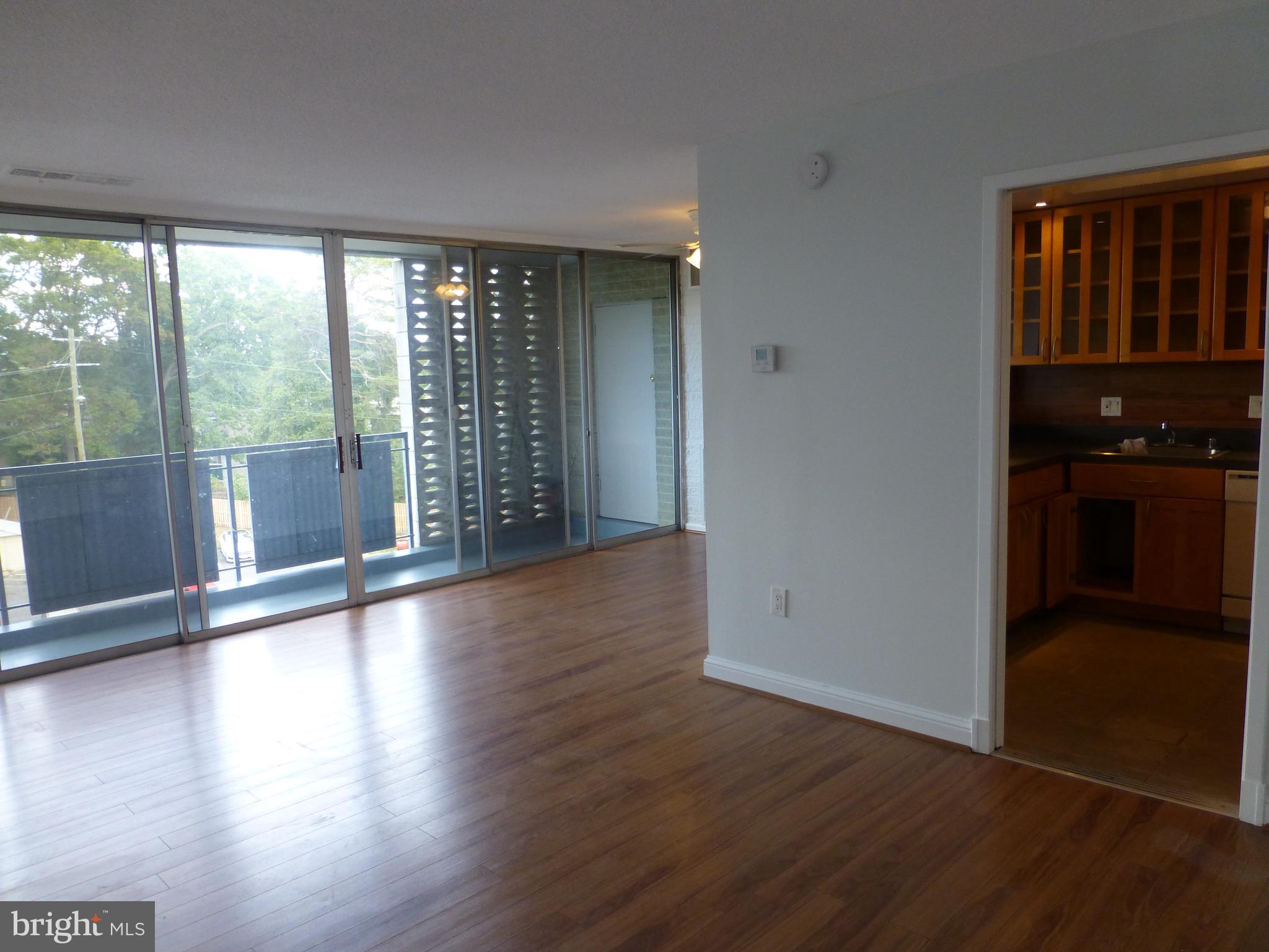 1826 Metzerott Road, Unit 408 Adelphi, MD 20783 - Photo 4 of 14 Living/dining room with floor to ceiling glass.