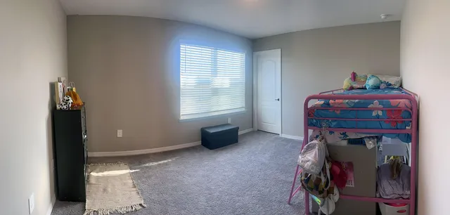 a bedroom with bed and a window