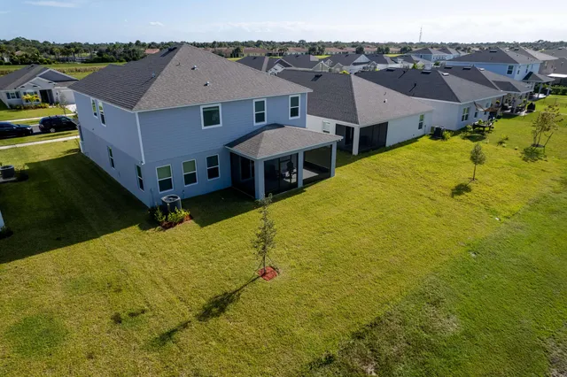 an aerial view of a house with a swimming pool