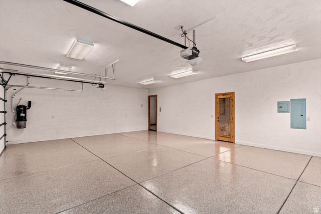 2464 East Granite Way St. George, UT 84790 - Photo 62 of 106 Garage featuring electric panel and a garage door opener