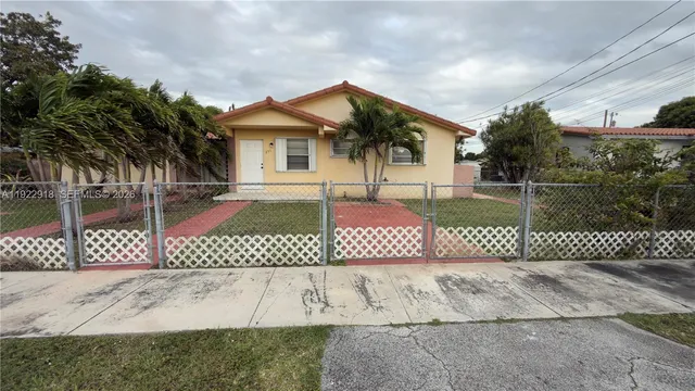 a front view of a house with a fence