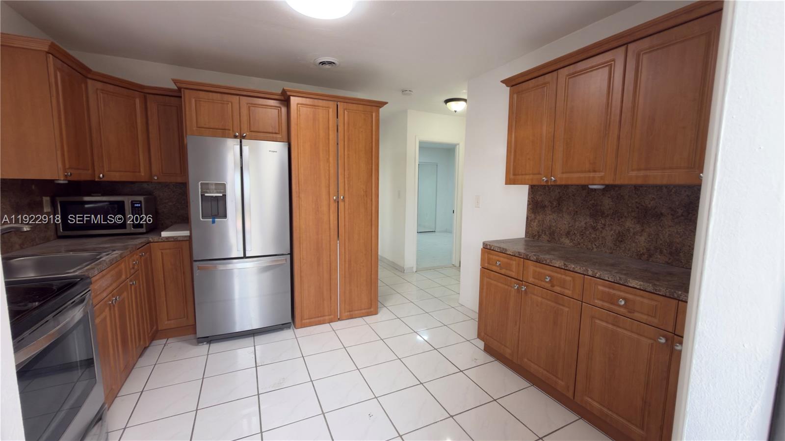 Fountainebleau Miami, FL 33144 - Photo 5 of 11 a kitchen with stainless steel appliances granite countertop a refrigerator a stove a sink and a microwave