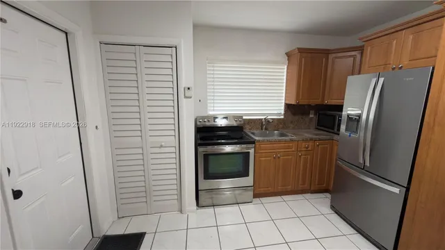 a kitchen with a refrigerator and a stove