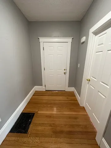 a view of a room with wooden floor and staircase