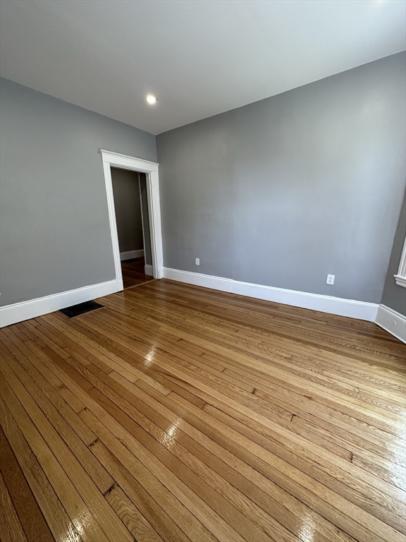 35 Harvard Street, Unit 2 Boston, MA 02124 - Photo 15 of 22 a view of empty room with wooden floor