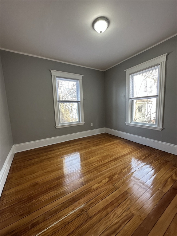 35 Harvard Street, Unit 2 Boston, MA 02124 - Photo 20 of 22 a view of empty room with wooden floor and fan