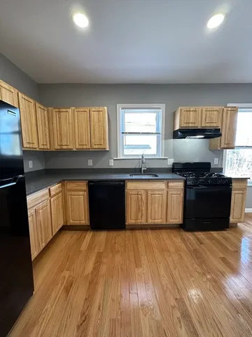a kitchen with a sink and a stove top oven